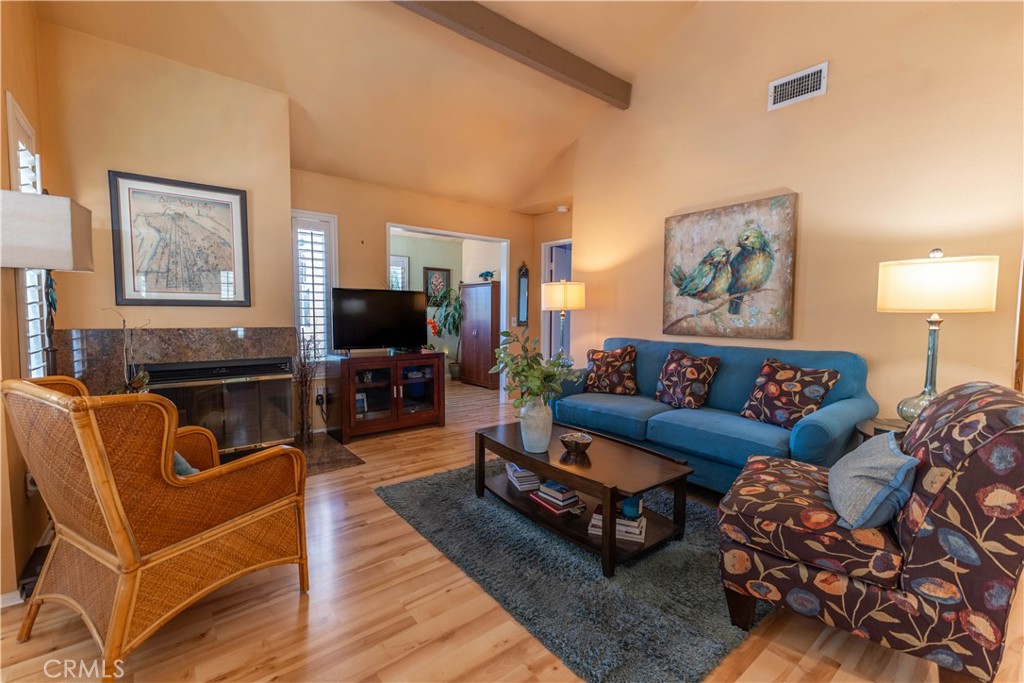 Living room with fireplace and vaulted ceiling